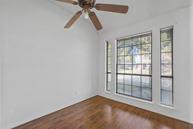 unfurnished room featuring hardwood / wood-style floors and vaulted ceiling