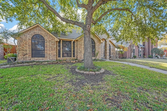 ranch-style house with a front lawn