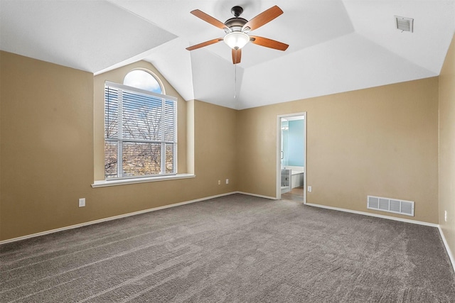 spare room featuring ceiling fan, carpet floors, and vaulted ceiling