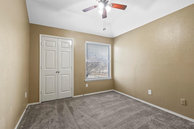 unfurnished bedroom with carpet, ceiling fan, and a closet