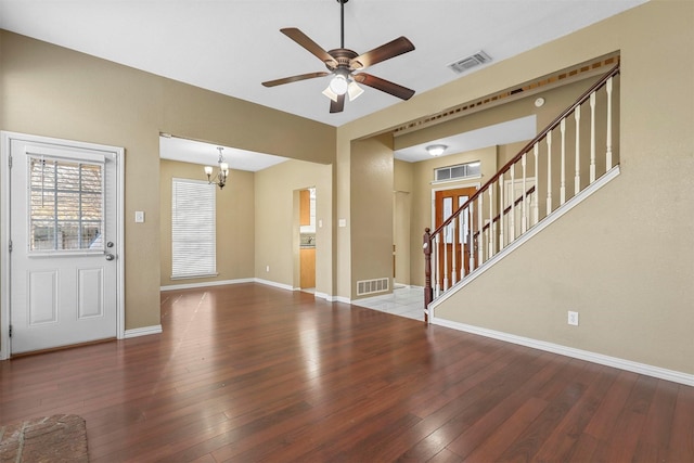 interior space with ceiling fan with notable chandelier and wood-type flooring