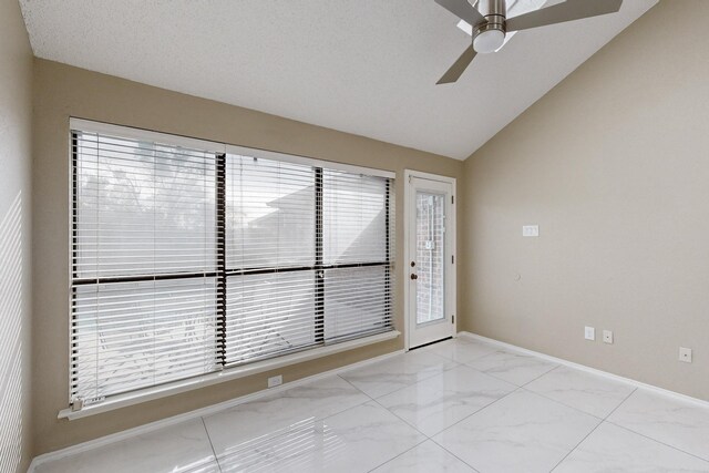 empty room featuring a textured ceiling, vaulted ceiling, and ceiling fan