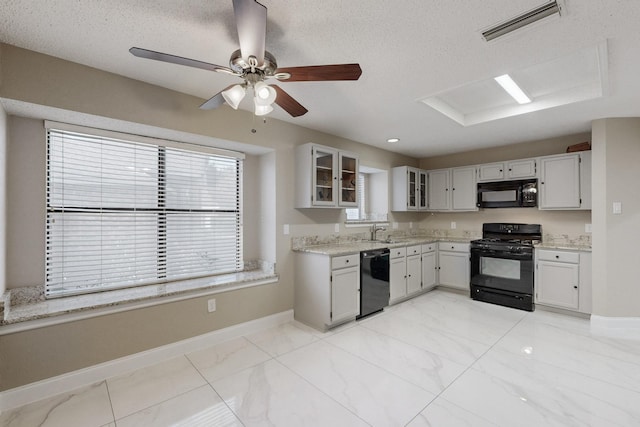 kitchen featuring black appliances, sink, ceiling fan, a textured ceiling, and white cabinetry