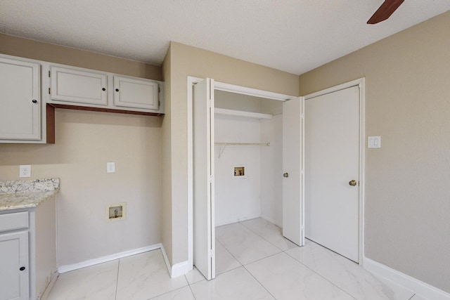 laundry room featuring washer hookup, a textured ceiling, and ceiling fan