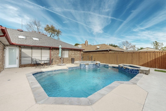 view of swimming pool with a patio area, an in ground hot tub, and pool water feature