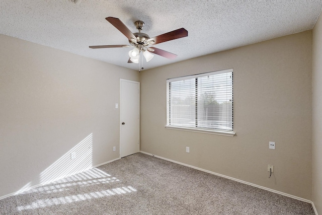 carpeted empty room featuring ceiling fan and a textured ceiling