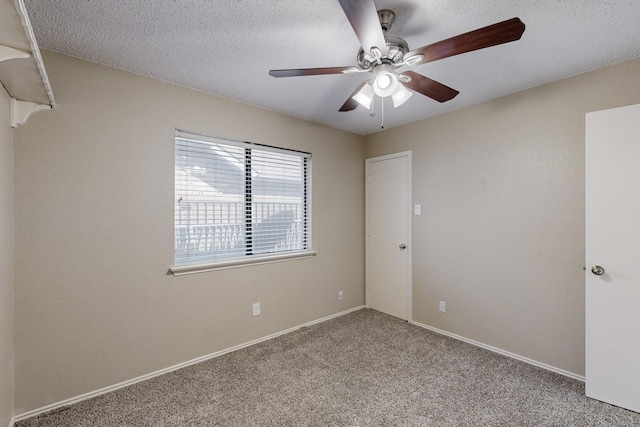 carpeted spare room with ceiling fan and a textured ceiling