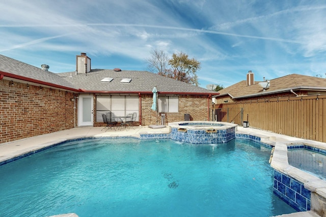 view of swimming pool featuring an in ground hot tub, pool water feature, and a patio