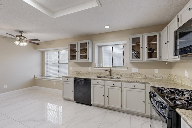 kitchen with white cabinetry, sink, black appliances, and a textured ceiling