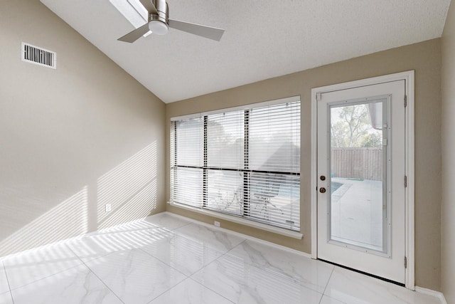 interior space with ceiling fan and lofted ceiling