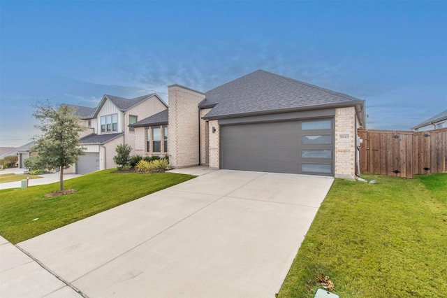 view of front of home featuring a front yard and a garage