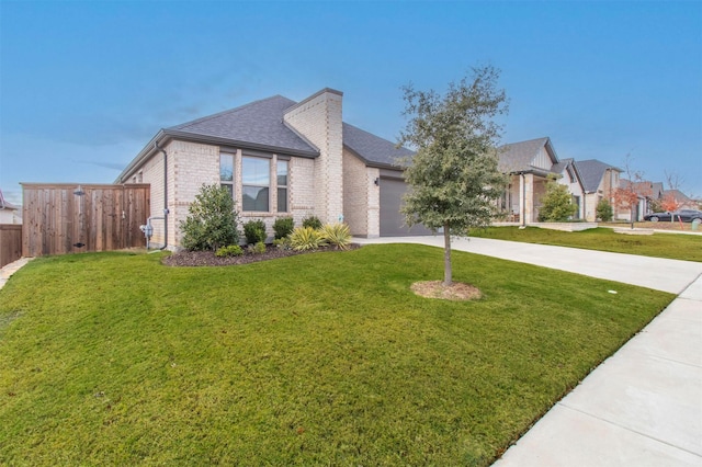 view of front of property with a garage and a front yard