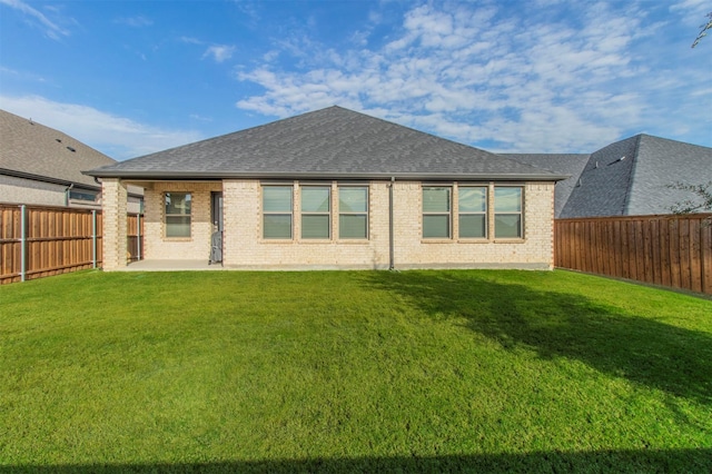 rear view of house with a lawn