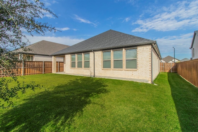 rear view of property featuring a lawn