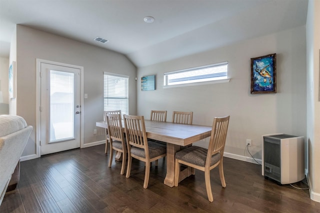 dining room featuring dark hardwood / wood-style flooring, vaulted ceiling, and plenty of natural light