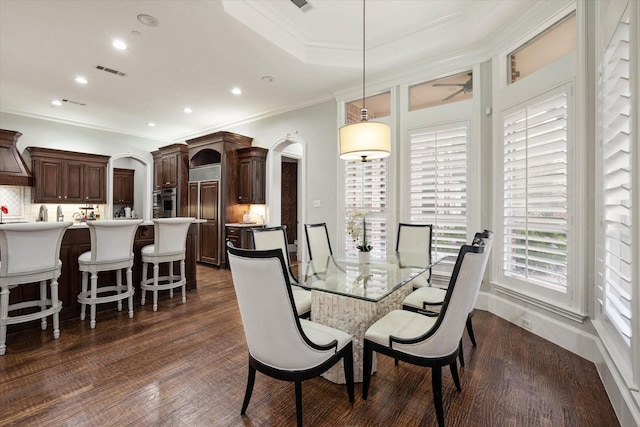 dining room featuring ornamental molding, ceiling fan, and dark wood-type flooring