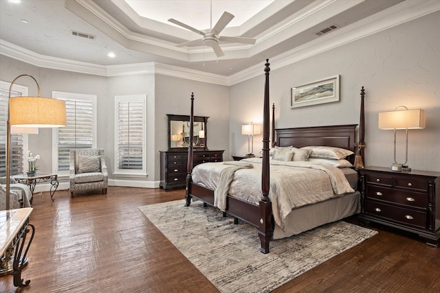 bedroom featuring ceiling fan, dark hardwood / wood-style floors, ornamental molding, and a tray ceiling