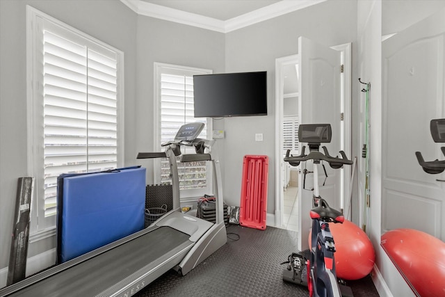 exercise area featuring tile patterned flooring and ornamental molding