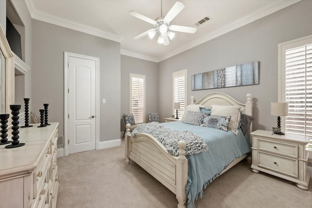 carpeted bedroom featuring ceiling fan and crown molding