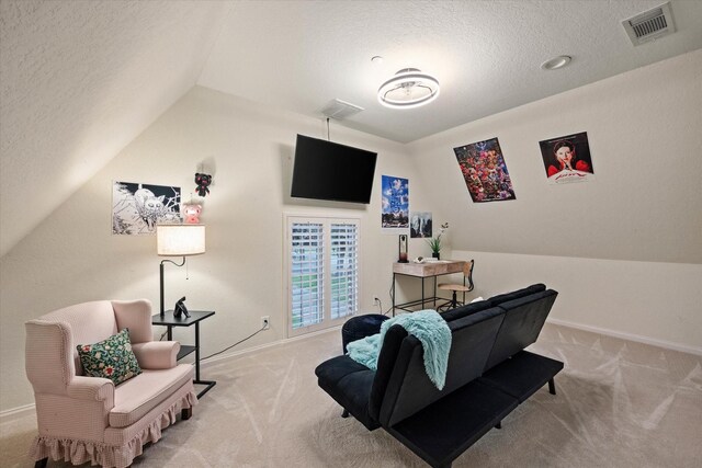 interior space featuring a textured ceiling, light carpet, and vaulted ceiling