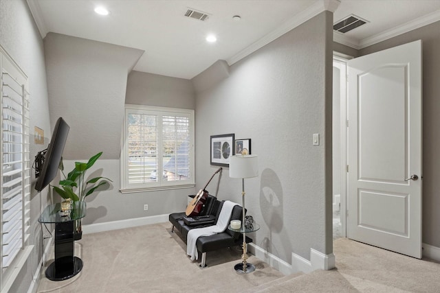 sitting room with ornamental molding and light carpet