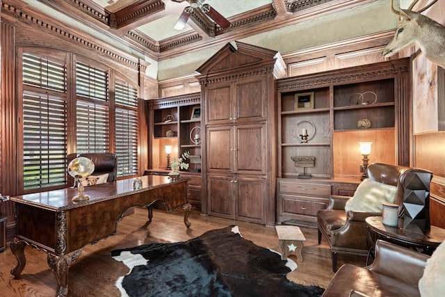 office featuring coffered ceiling, ceiling fan, built in features, ornamental molding, and wood-type flooring