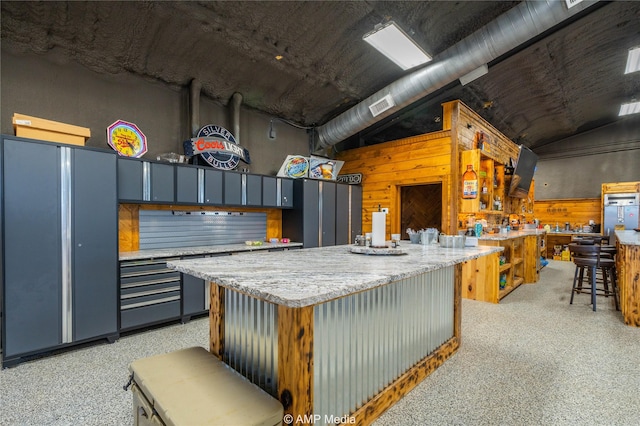 kitchen featuring vaulted ceiling and a kitchen island