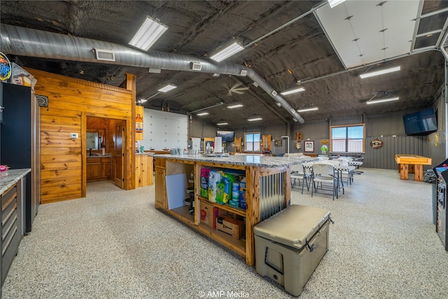 kitchen featuring wood walls