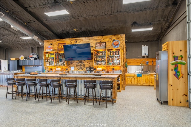 bar featuring stainless steel fridge