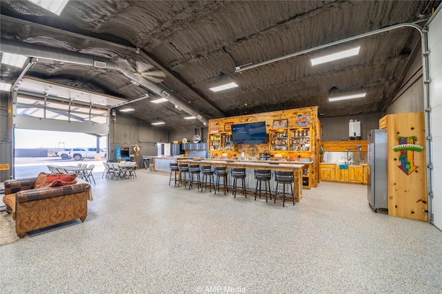 garage featuring a water view and stainless steel refrigerator