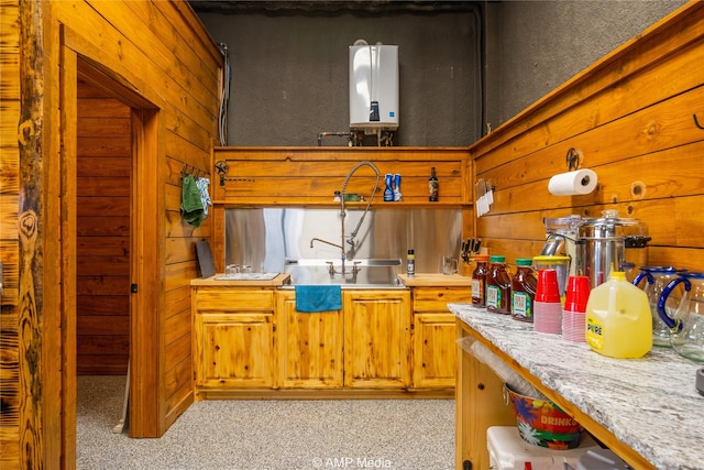 kitchen with light colored carpet, tankless water heater, and wood walls