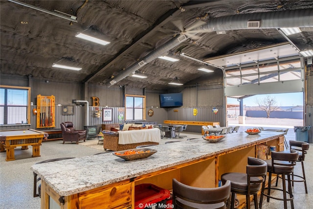 kitchen with billiards and light stone countertops