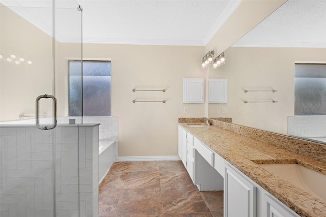 bathroom featuring vanity, a tub to relax in, ornamental molding, and a textured ceiling