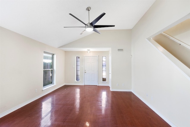 entryway with ceiling fan, dark wood-type flooring, and vaulted ceiling