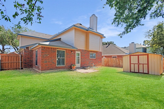 rear view of property with a shed, a yard, and a patio area