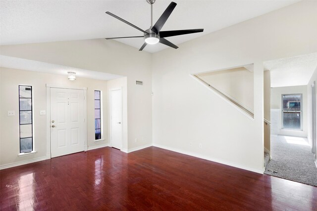 foyer entrance with vaulted ceiling, ceiling fan, and dark wood-type flooring