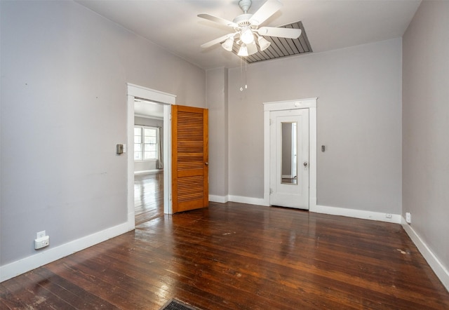 unfurnished room with ceiling fan and dark hardwood / wood-style flooring