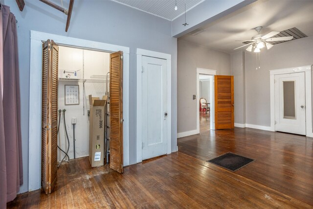 interior space with beam ceiling and dark hardwood / wood-style flooring