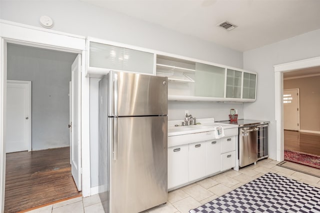 kitchen featuring white cabinetry, appliances with stainless steel finishes, and sink