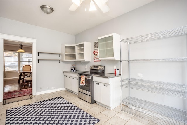 kitchen featuring light tile patterned floors, white cabinetry, stainless steel electric range oven, and ceiling fan