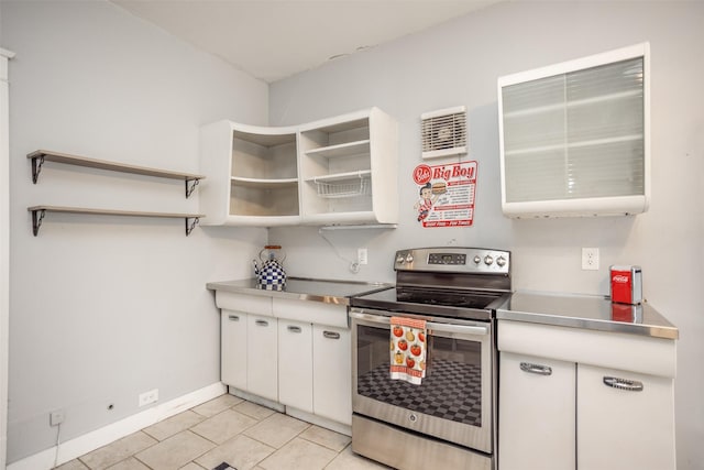 kitchen featuring electric stove, white cabinetry, and stainless steel counters