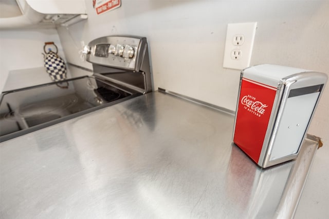 kitchen with concrete flooring and stainless steel electric range