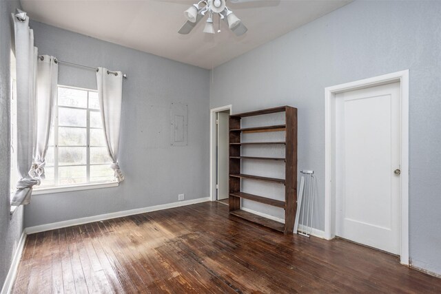 unfurnished bedroom with ceiling fan and dark wood-type flooring