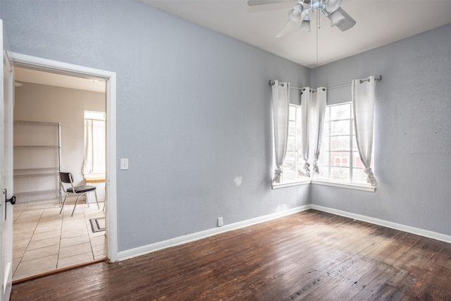 empty room featuring wood-type flooring and ceiling fan