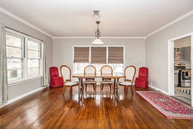 dining area with dark hardwood / wood-style floors and crown molding