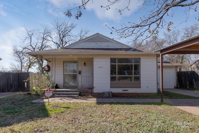 bungalow-style house with a garage and a front yard