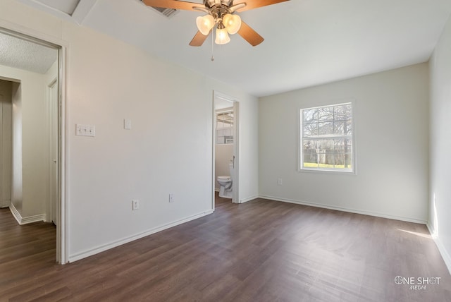 unfurnished room with dark hardwood / wood-style floors and ceiling fan