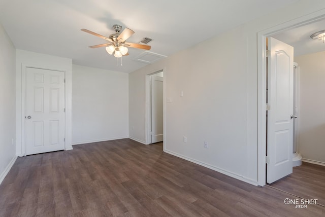 spare room featuring ceiling fan and dark wood-type flooring