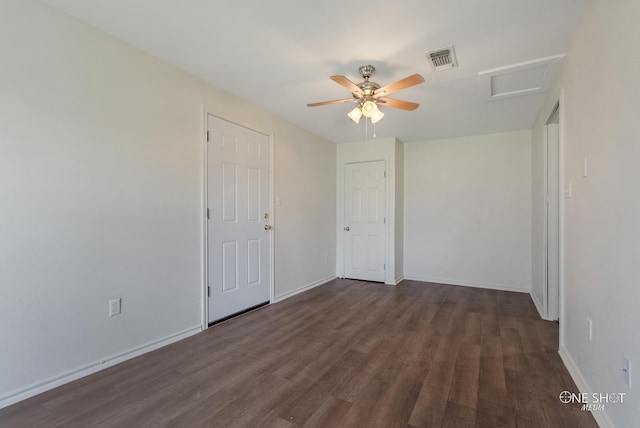 empty room with ceiling fan and dark wood-type flooring