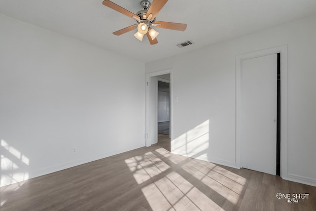 unfurnished bedroom with ceiling fan, a closet, and light wood-type flooring